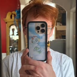 Photo of Matt Morris, red hair, glasses, holding his iPhone in the mirror, taking a picture of himself.